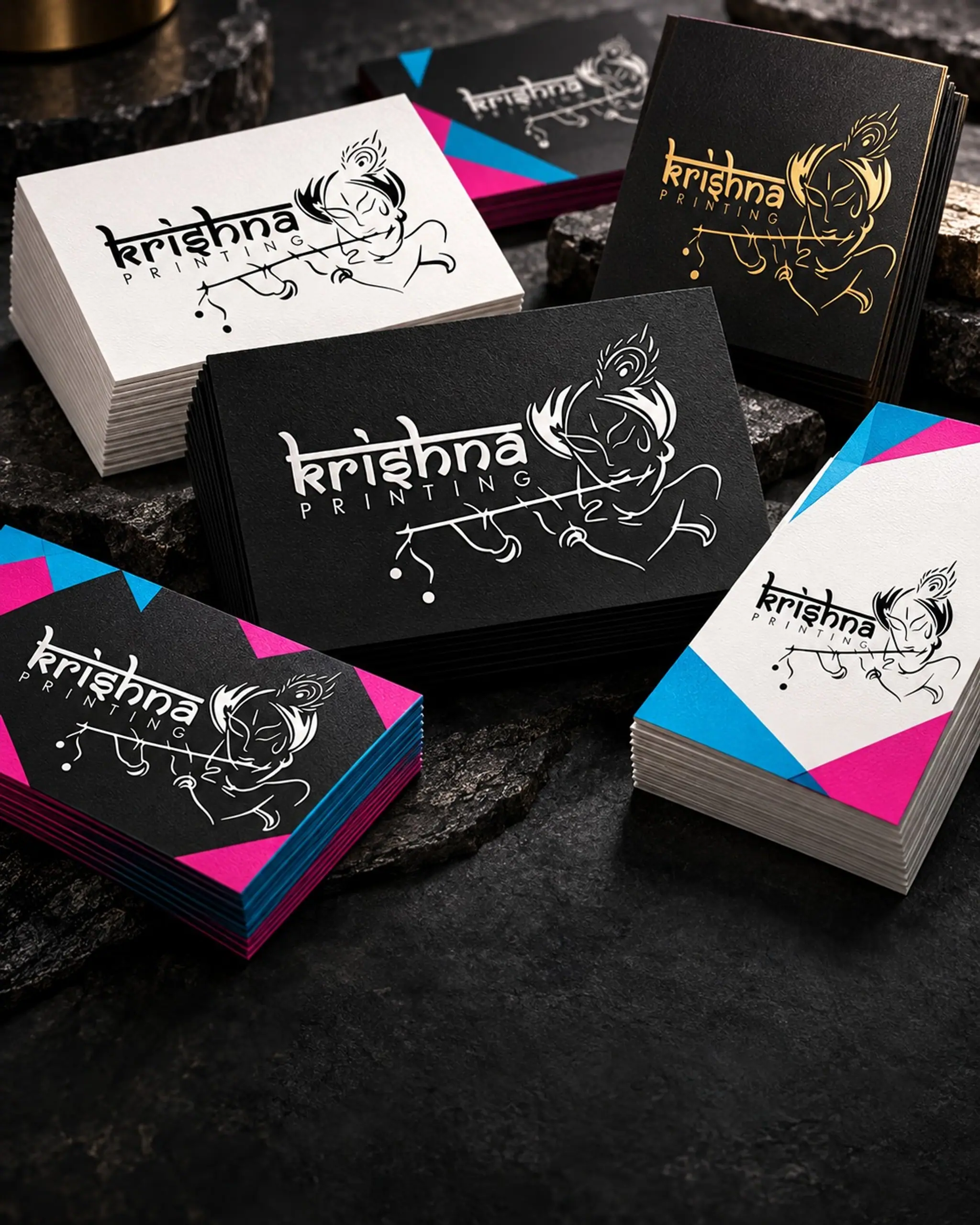 Stacks of black and white Krishna Printing business cards with colour-painted edges