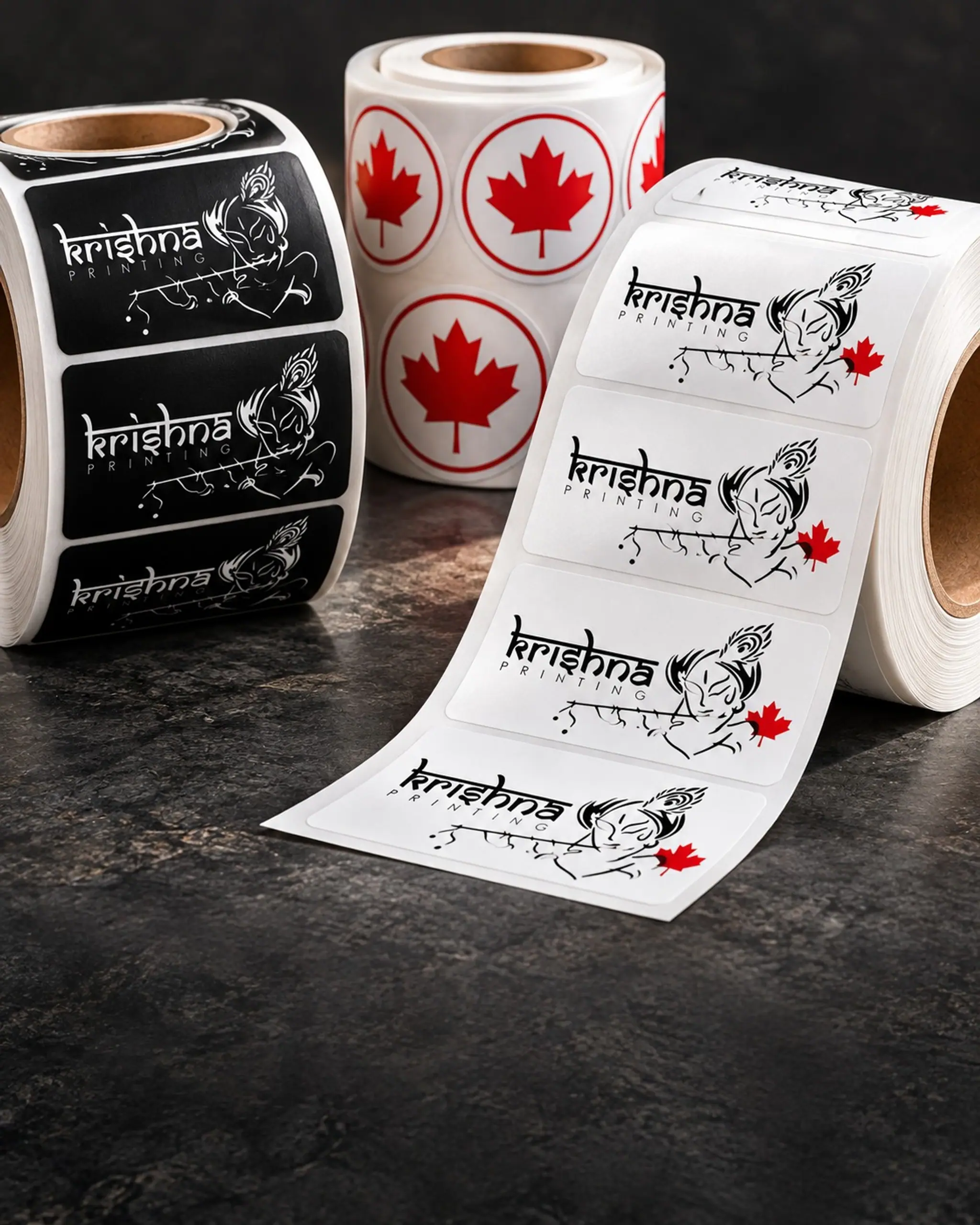 Rolls of printed Krishna Printing product labels and maple-leaf stickers