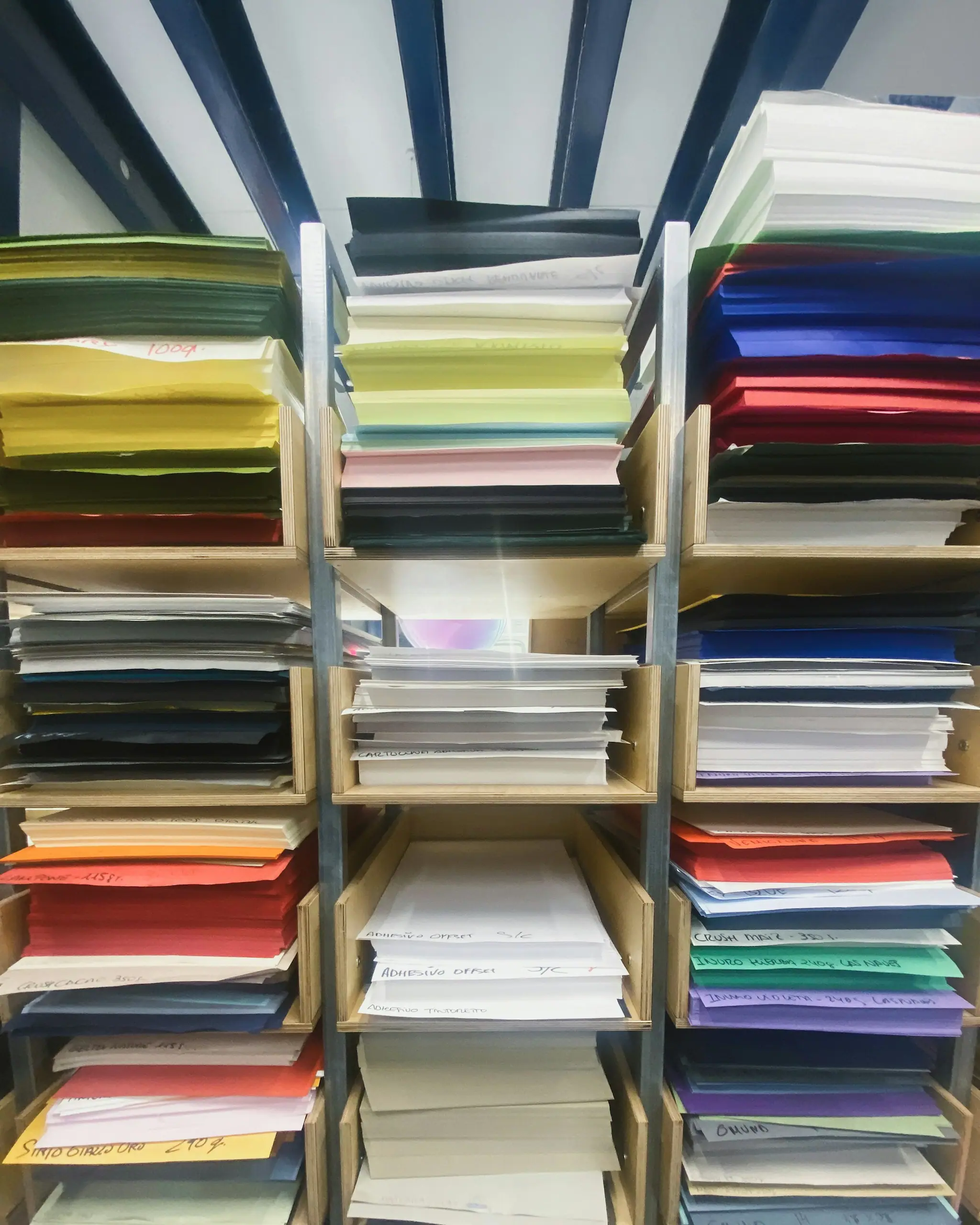 Shelves stacked with coloured paper and card stock