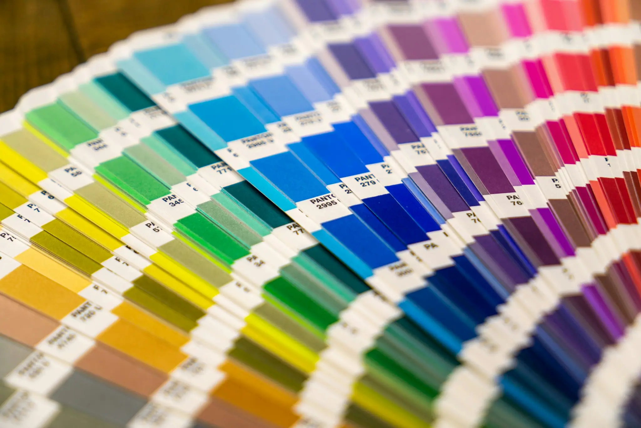 Colour swatch fan deck spread across a table