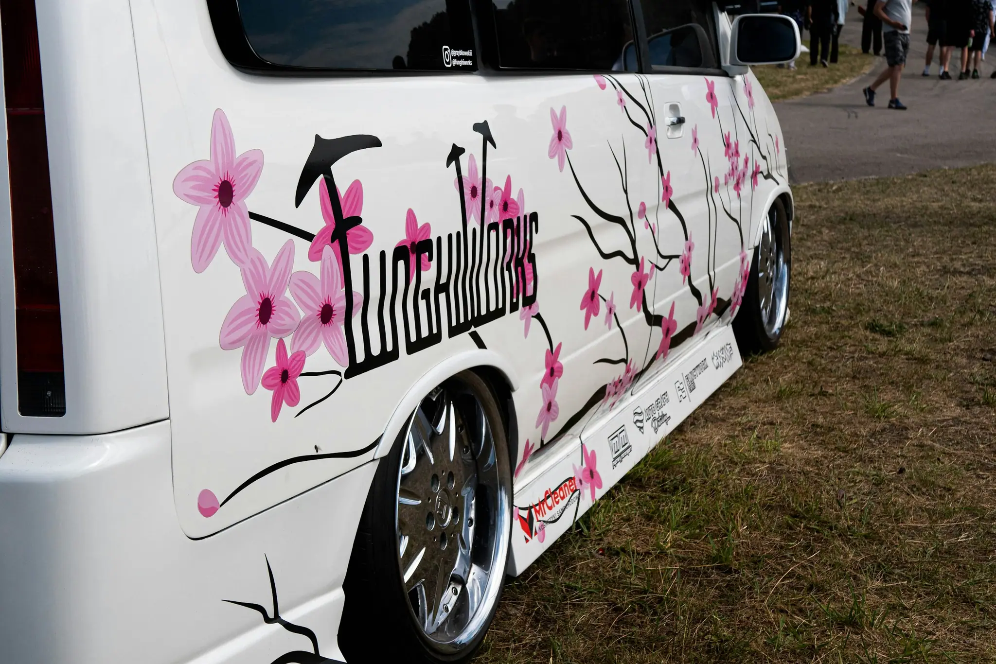 White van with custom cherry blossom graphics